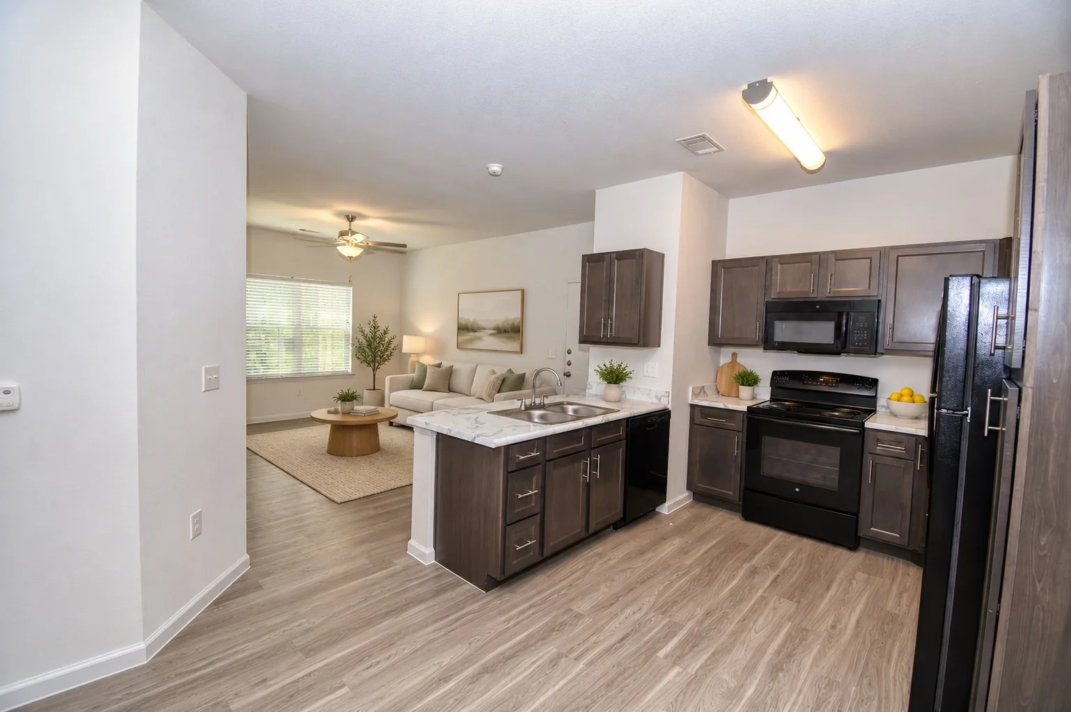 Existing virtually staged kitchen and living room at Abbington Ranch